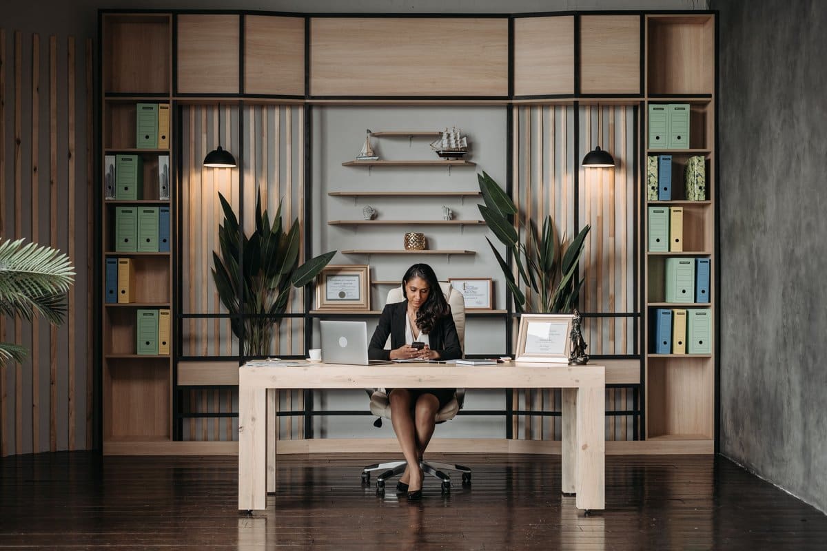 A professional working at a desk with organized document folders, representing paralegal certification study and case preparation