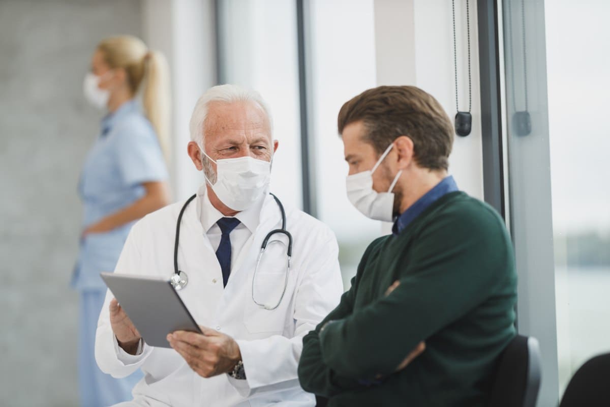 A doctor consulting with a patient in a clinic setting, representative of healthcare and caregiving second-career environments